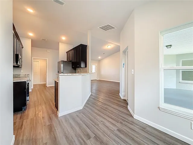 a room with wooden floor and mirror