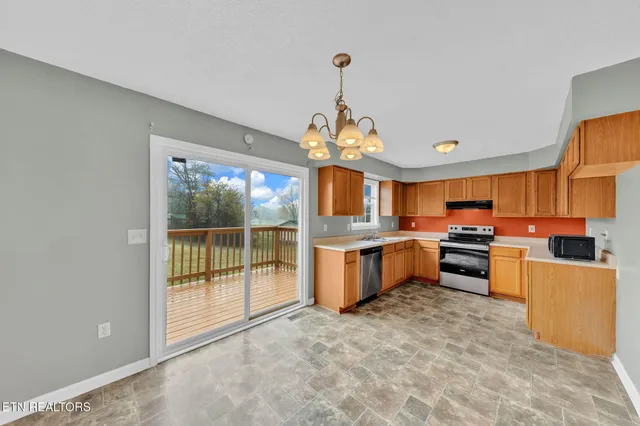 a kitchen with stove a sink and refrigerator