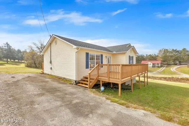 a view of a house with a swimming pool and sitting area