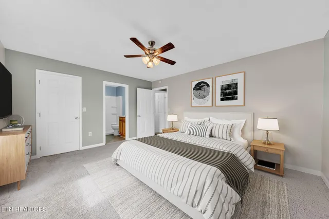 a spacious bedroom with a bed and a view of bathroom