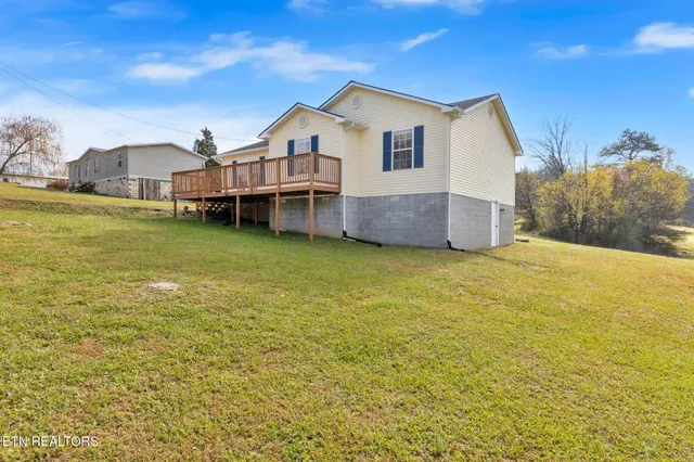 a view of a house next to a big yard