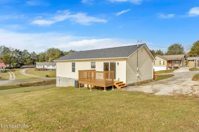 a view of a house with backyard and sitting area