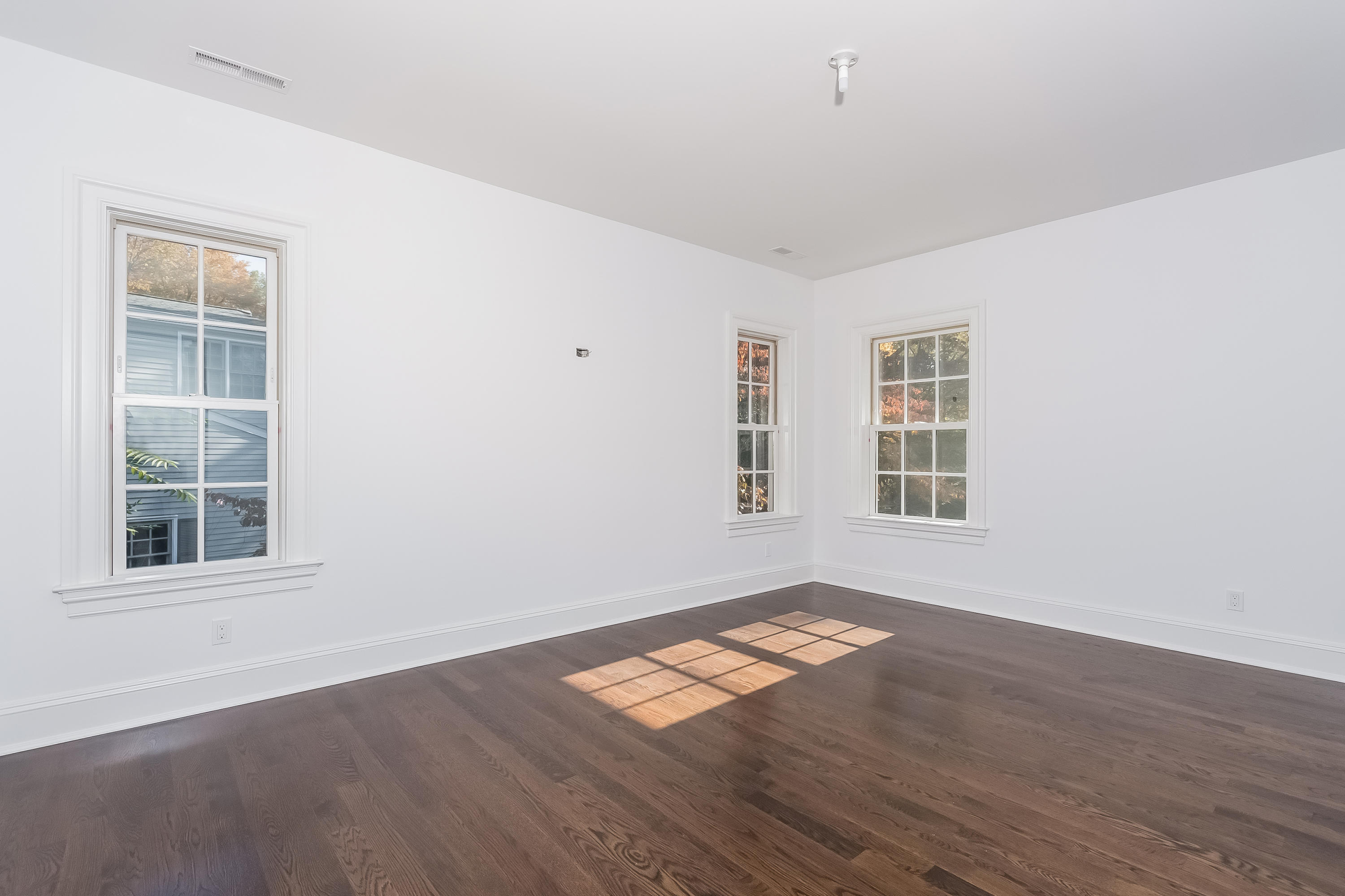 36 Briar Brae Road Darien, CT 06820 - Photo 27 of 37 an empty room with wooden floor and windows