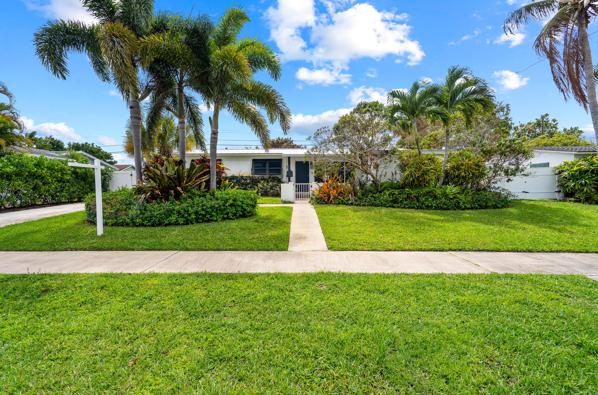 520 Flotilla Road North Palm Beach, FL 33408 - Photo 1 of 30 a view of a house with a big yard and palm trees