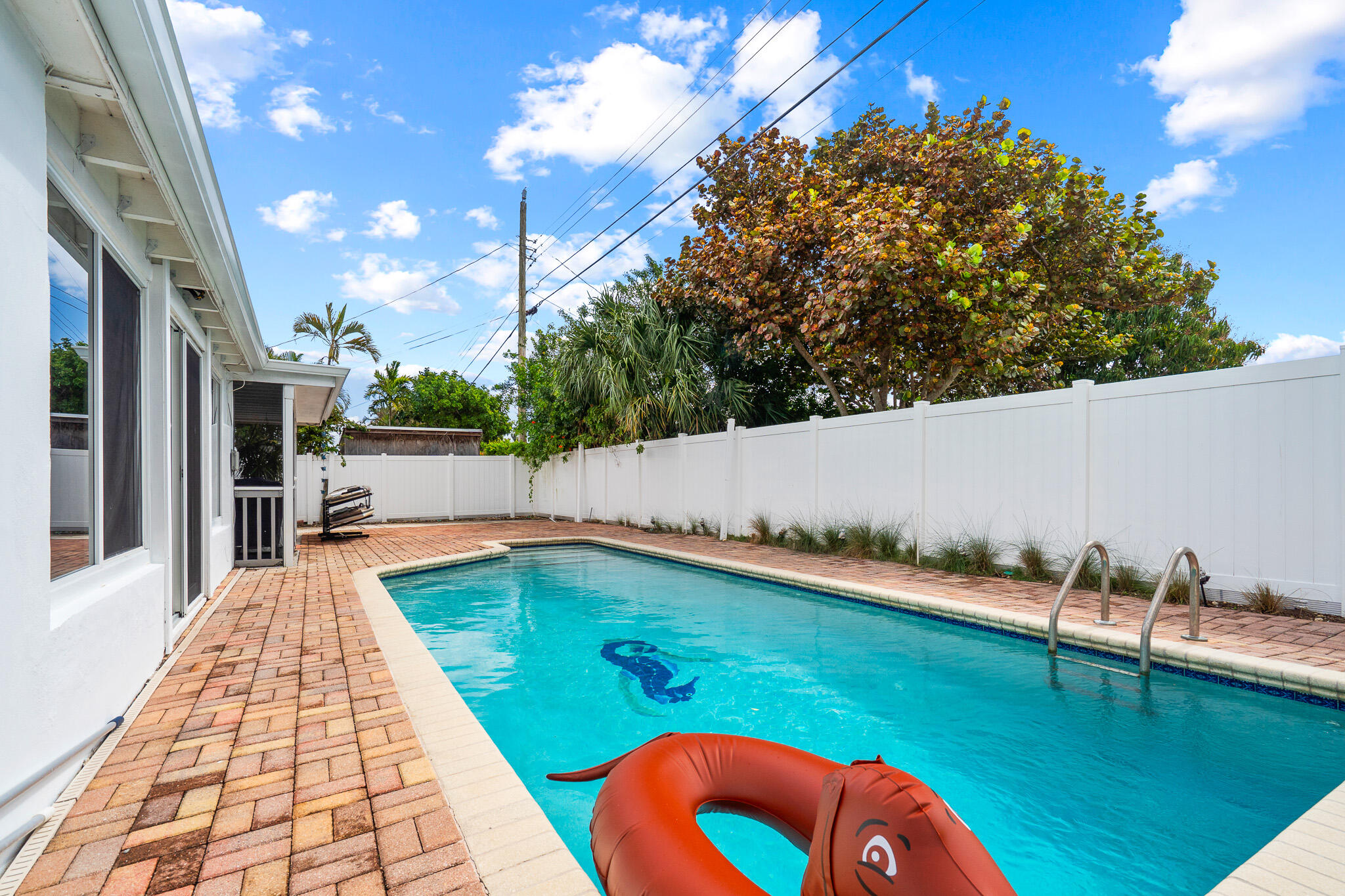 520 Flotilla Road North Palm Beach, FL 33408 - Photo 30 of 30 a view of a swimming pool with an outdoor seating and a yard