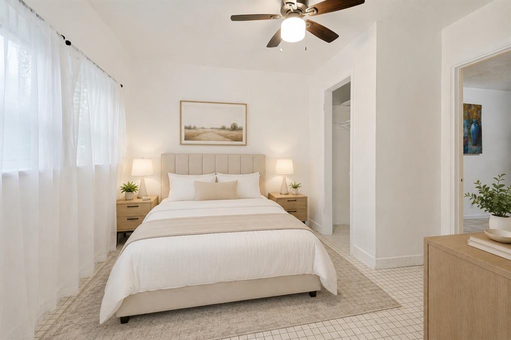 403 North Britain Road, Unit 403B Irving, TX 75061 - Photo 7 of 15 Bright bedroom featuring white walls, a ceiling fan with integrated lighting, and a neutral tile floor