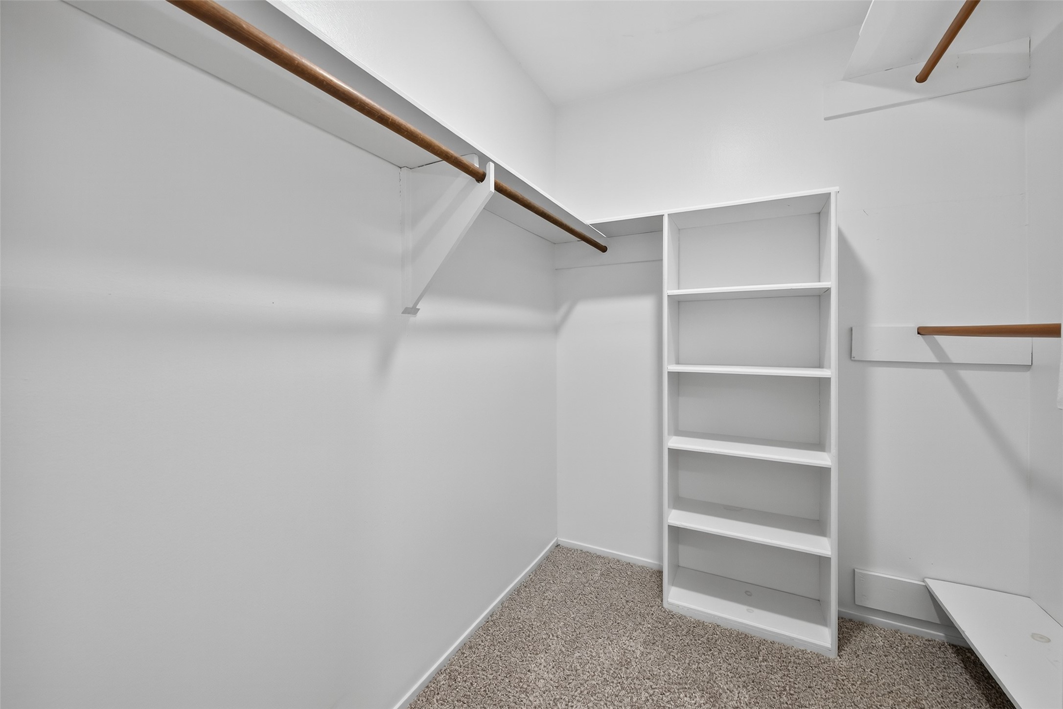 6410 Del Monte Drive, Unit 93 Houston, TX 77057 - Photo 14 of 19 a view of walk in closet with empty racks