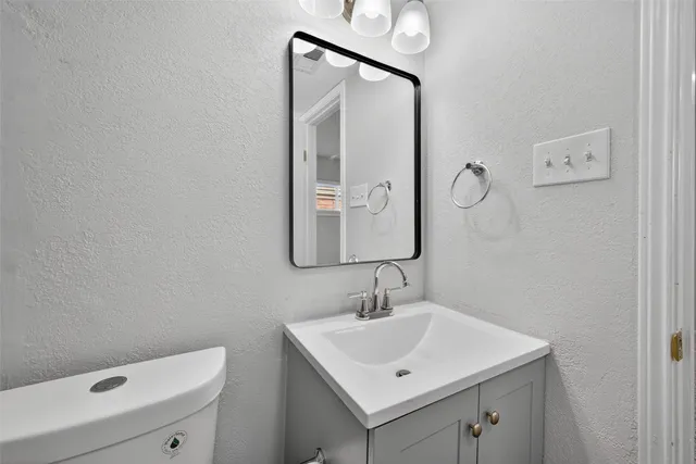 a bathroom with a sink vanity and mirror