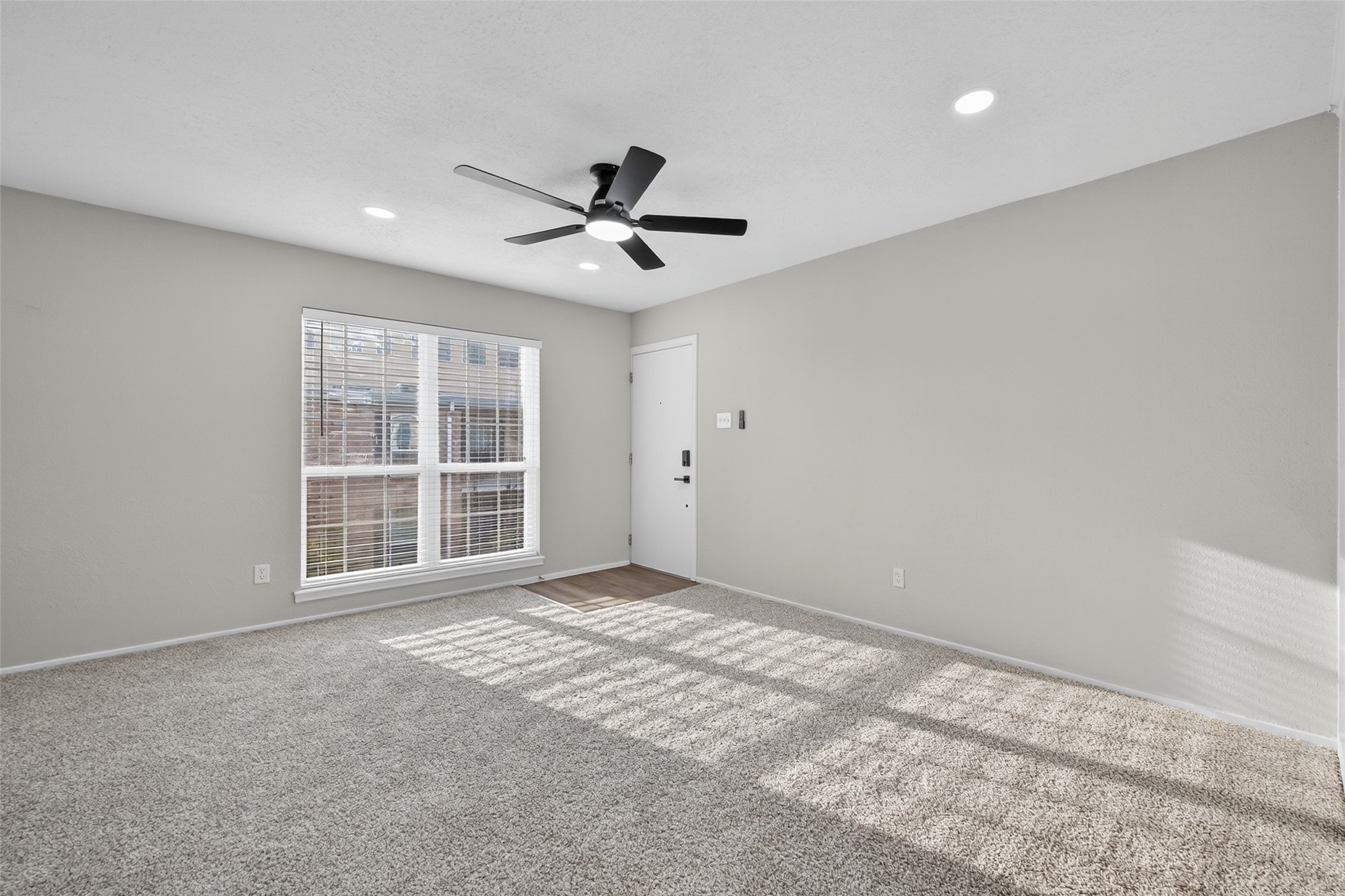 6410 Del Monte Drive, Unit 93 Houston, TX 77057 - Photo 5 of 19 a view of empty room with wooden floor and windows