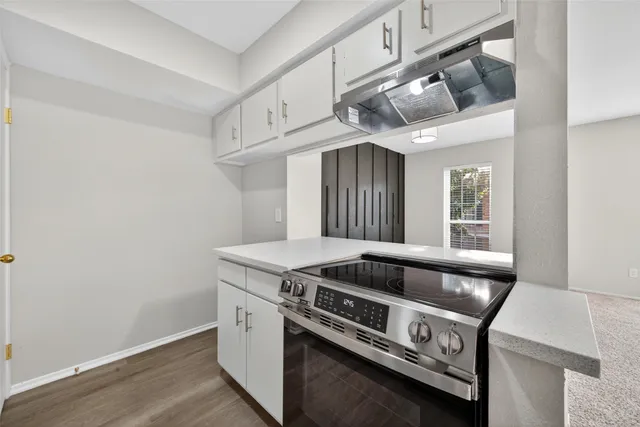 a view of a kitchen with furniture and windows