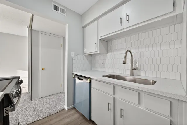 a kitchen with a sink and cabinets