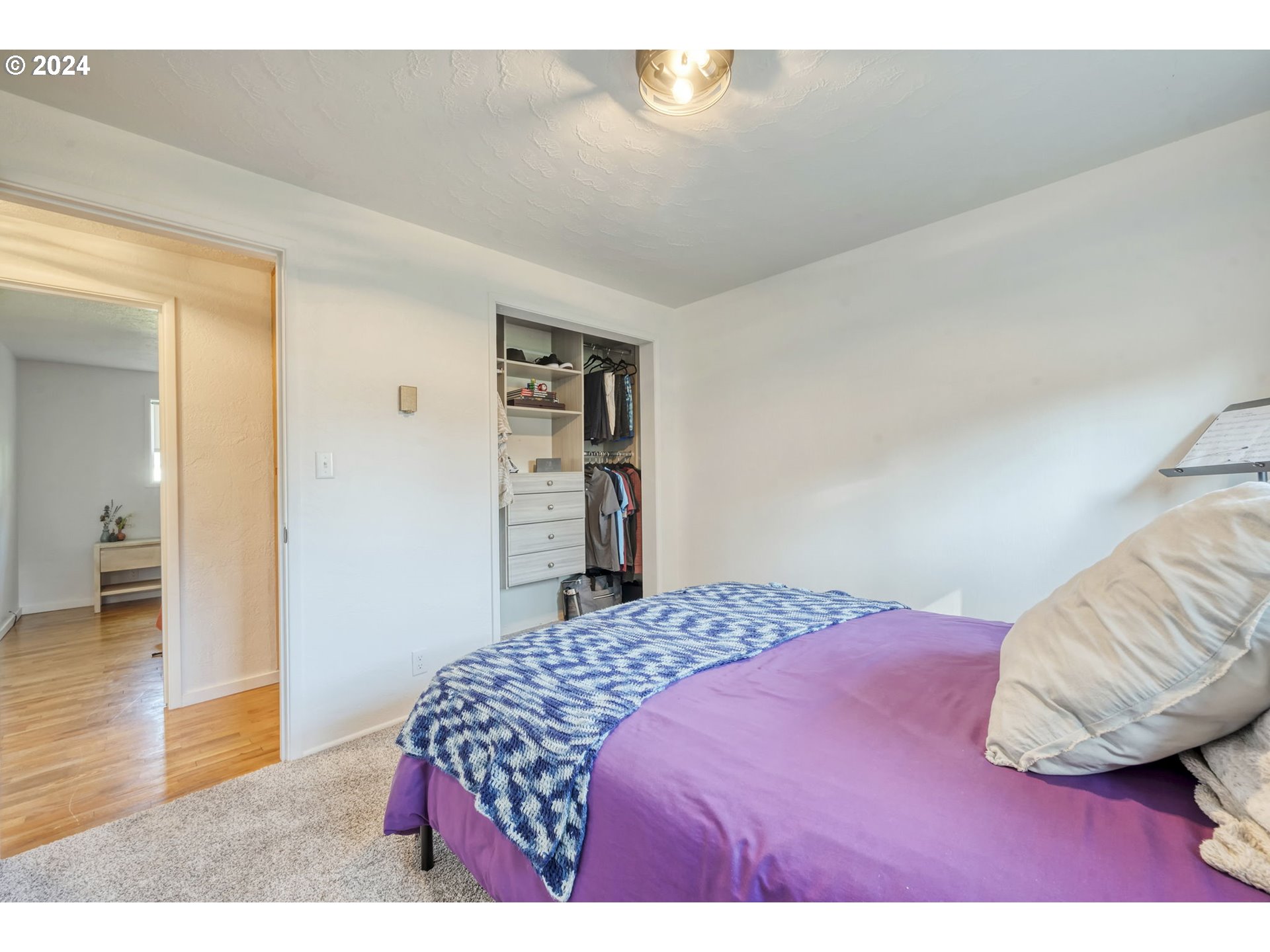 1127 South 34th Place Springfield, OR 97478 - Photo 25 of 40 a bedroom with a bed and a wooden floor