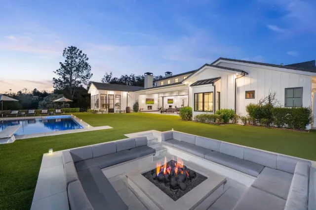 a view of a house with swimming pool and yard with furniture