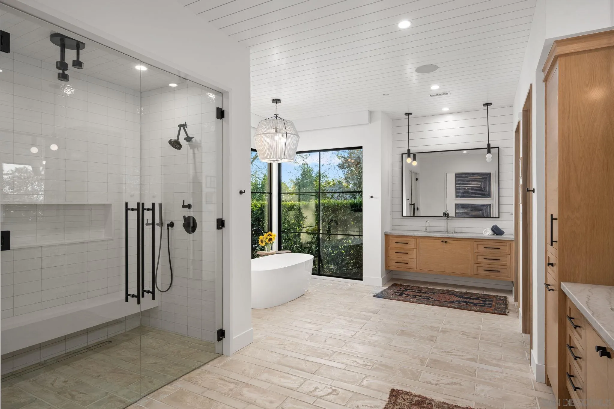 15550 El Camino Real Rancho Santa Fe, CA 92014 - Photo 24 of 35 a bathroom with a tub shower and sink