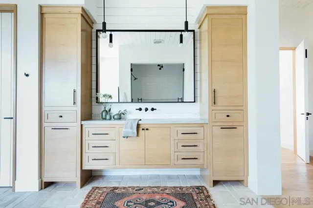 a bathroom with a sink a mirror and a shower