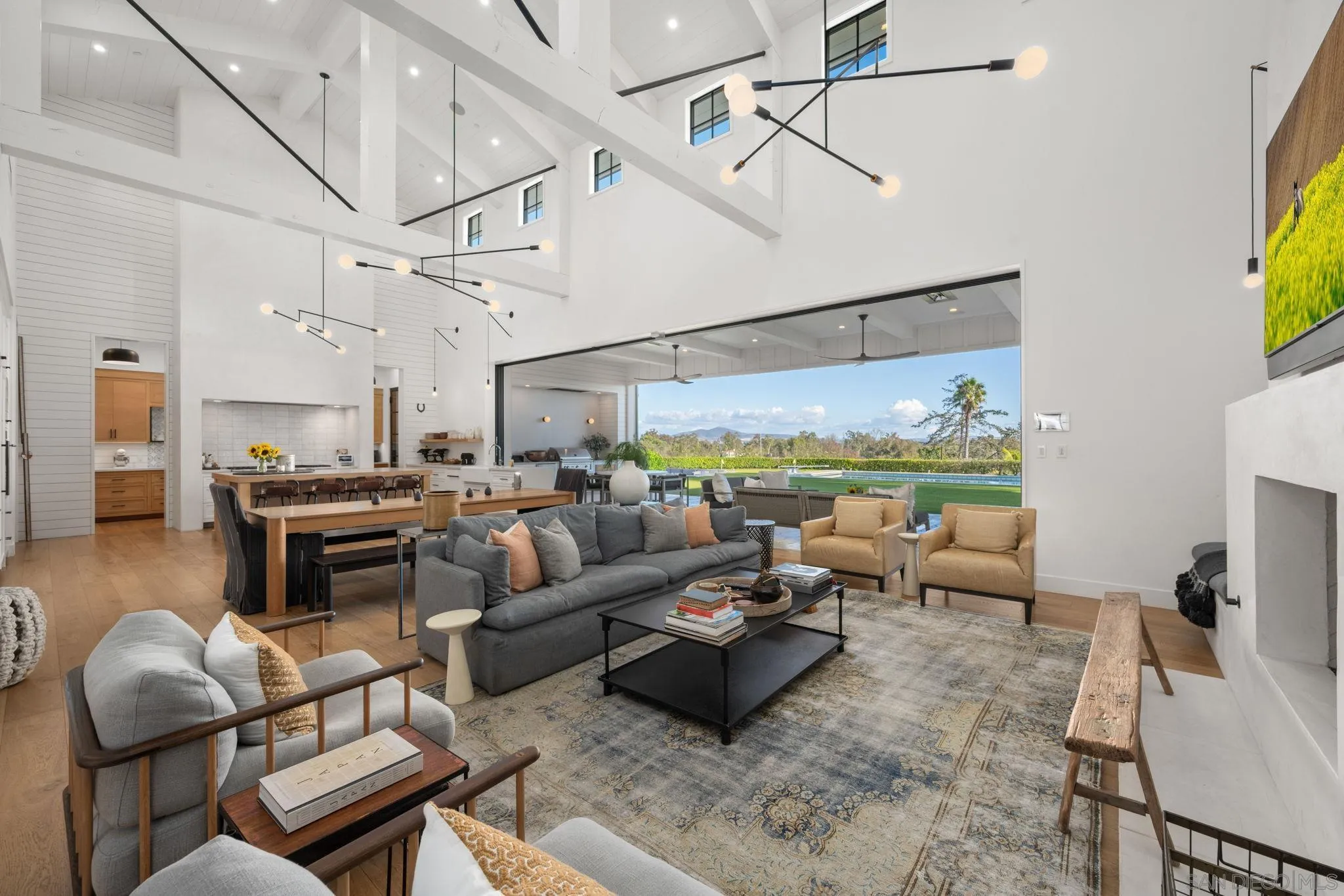 15550 El Camino Real Rancho Santa Fe, CA 92014 - Photo 7 of 35 a living room with lots of furniture and a chandelier