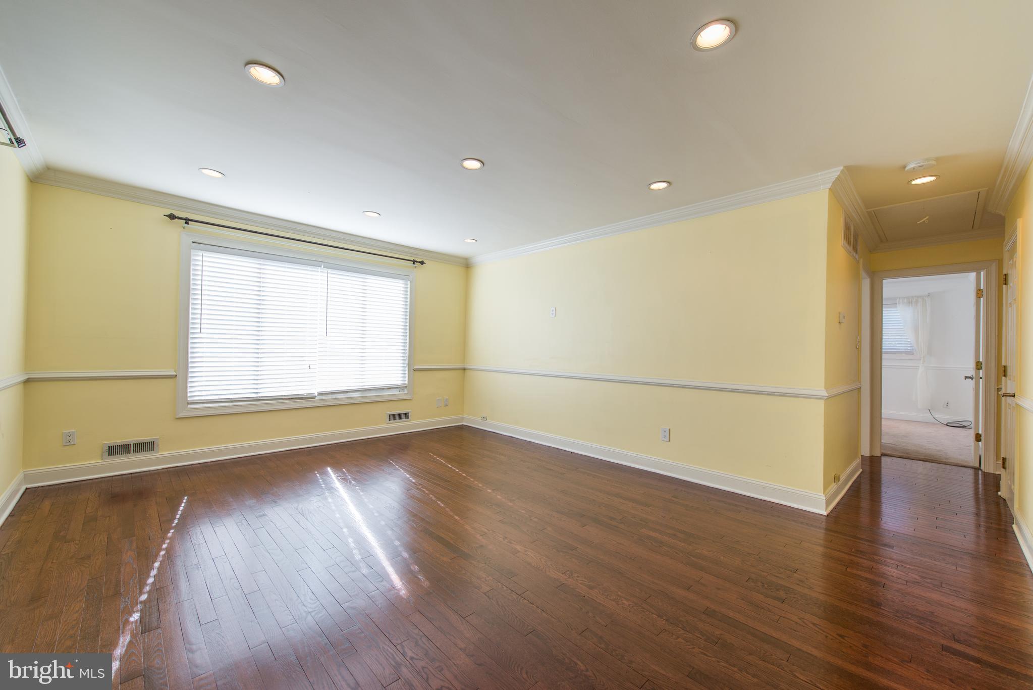 Living room features skylights and hardwood floors