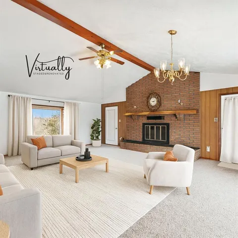 a living room with furniture and a chandelier