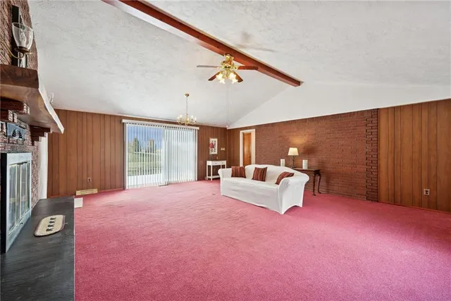 a view of a livingroom with furniture and a window