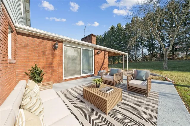 a balcony with wooden floor and furniture