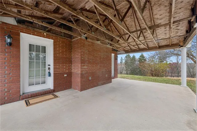 a view of a room with wooden walls and floor to ceiling window