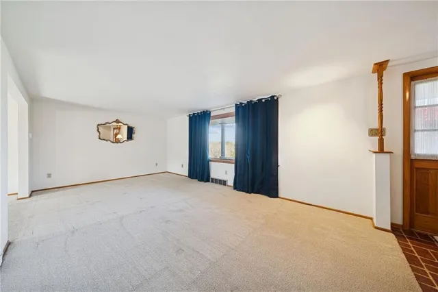 a view of an empty room and a window