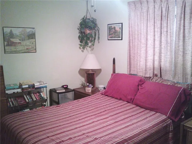 a bedroom with a bed and a table in it