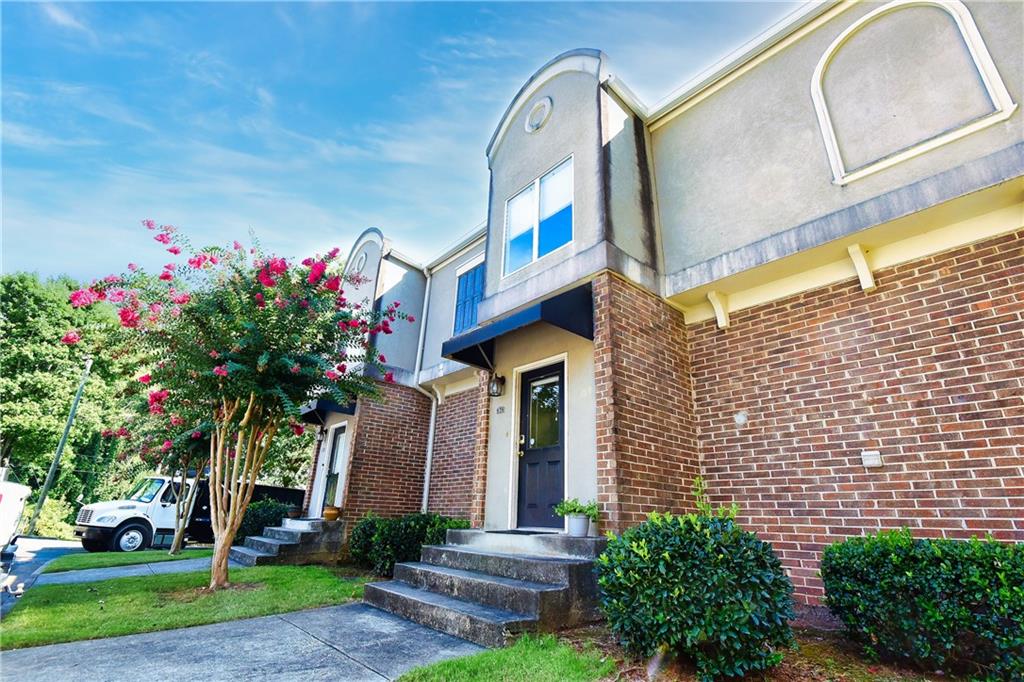 3301 Henderson Mill Road, Unit B2 Atlanta, GA 30341 - Photo 1 of 1 a front view of a house with a garden