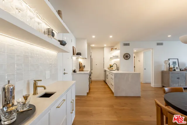 a large white kitchen with a large window