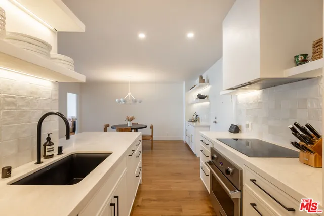 a kitchen with a sink and a refrigerator