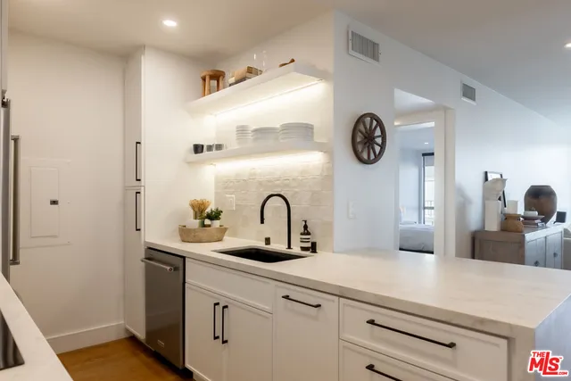a kitchen with a refrigerator and a sink