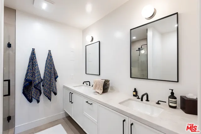 a bathroom with a sink double vanity and mirror