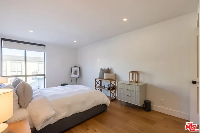 a bedroom with a bed and a mirror