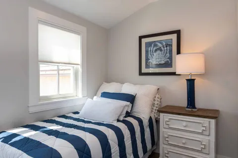 a bedroom with bed and window