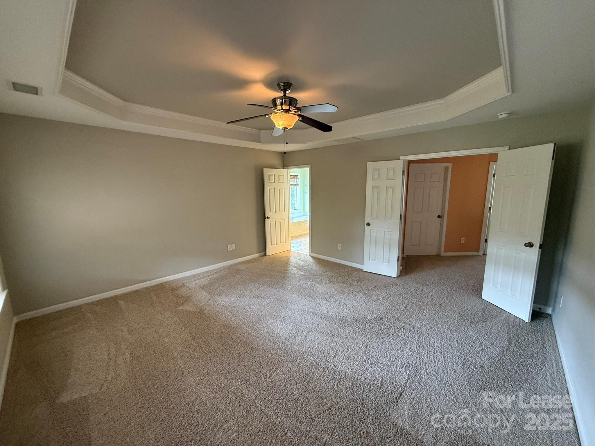 10431 Olde Ivy Way Charlotte, NC 28262 - Photo 11 of 24 an empty room with a ceiling fan and carpet
