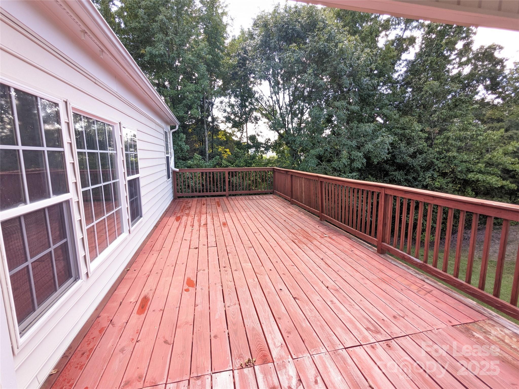 10431 Olde Ivy Way Charlotte, NC 28262 - Photo 13 of 24 a view of balcony with wooden floor and fence and a pathway