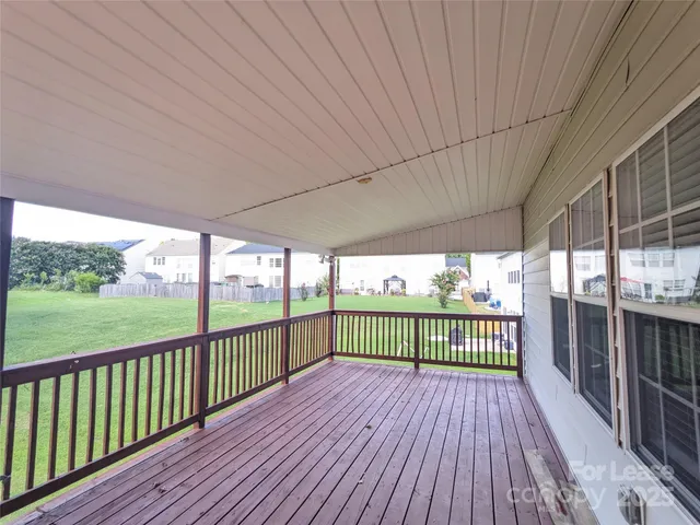 a view of a balcony with wooden floor