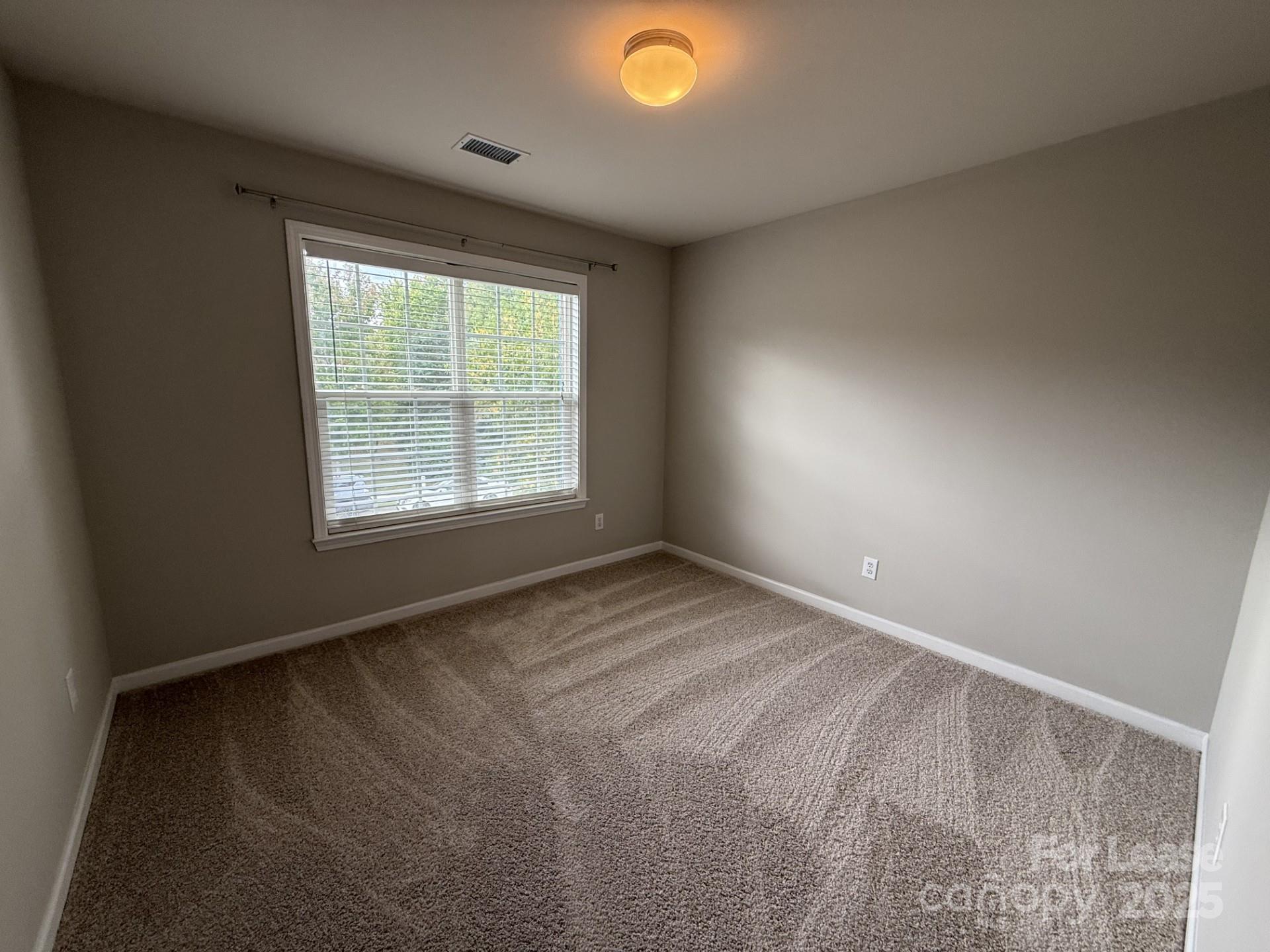 10431 Olde Ivy Way Charlotte, NC 28262 - Photo 17 of 24 a view of an empty room with a window