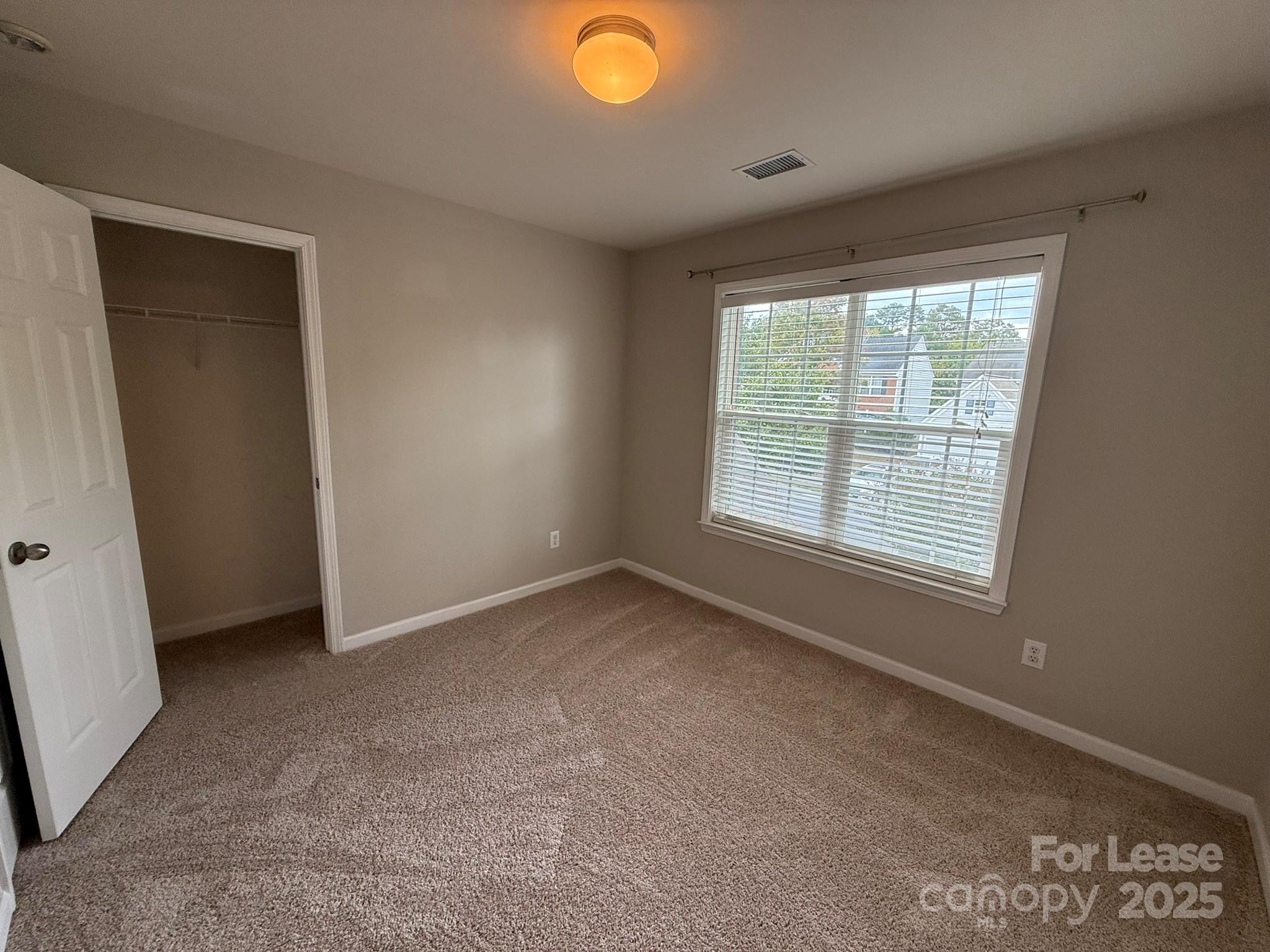 10431 Olde Ivy Way Charlotte, NC 28262 - Photo 18 of 24 a view of an empty room with a window