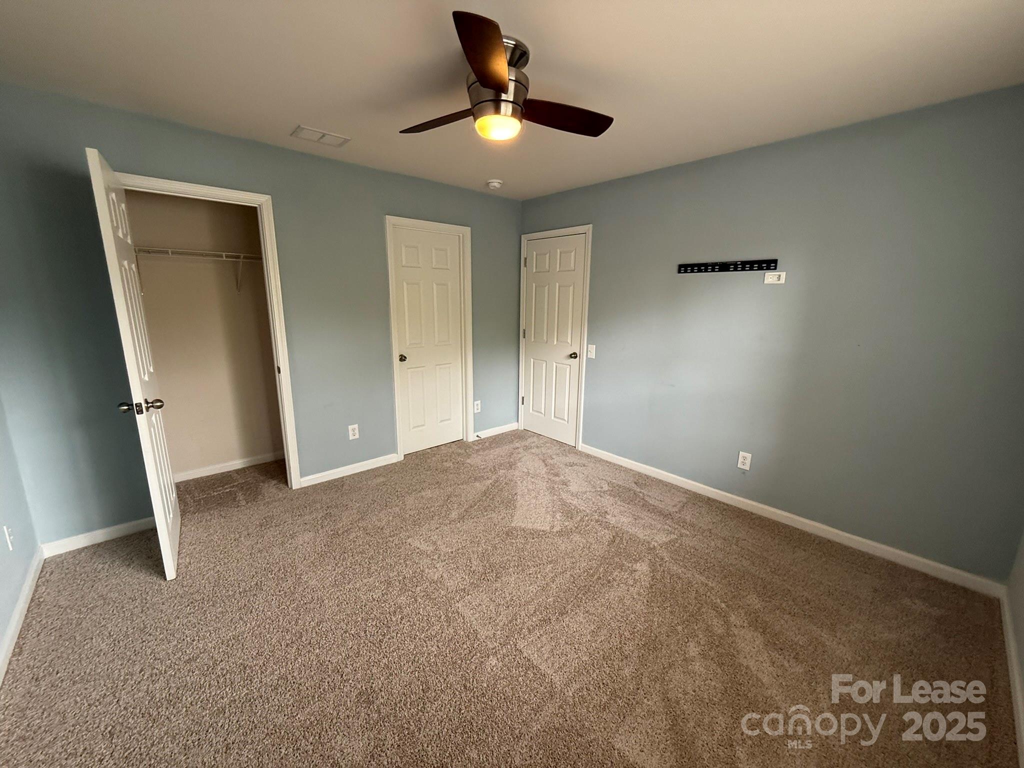 10431 Olde Ivy Way Charlotte, NC 28262 - Photo 20 of 24 a view of a livingroom with a ceiling fan and window