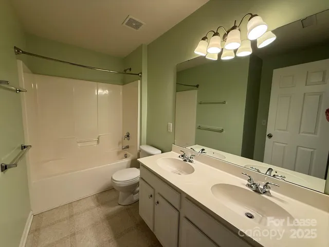 a bathroom with a double vanity sink mirror double and toilet