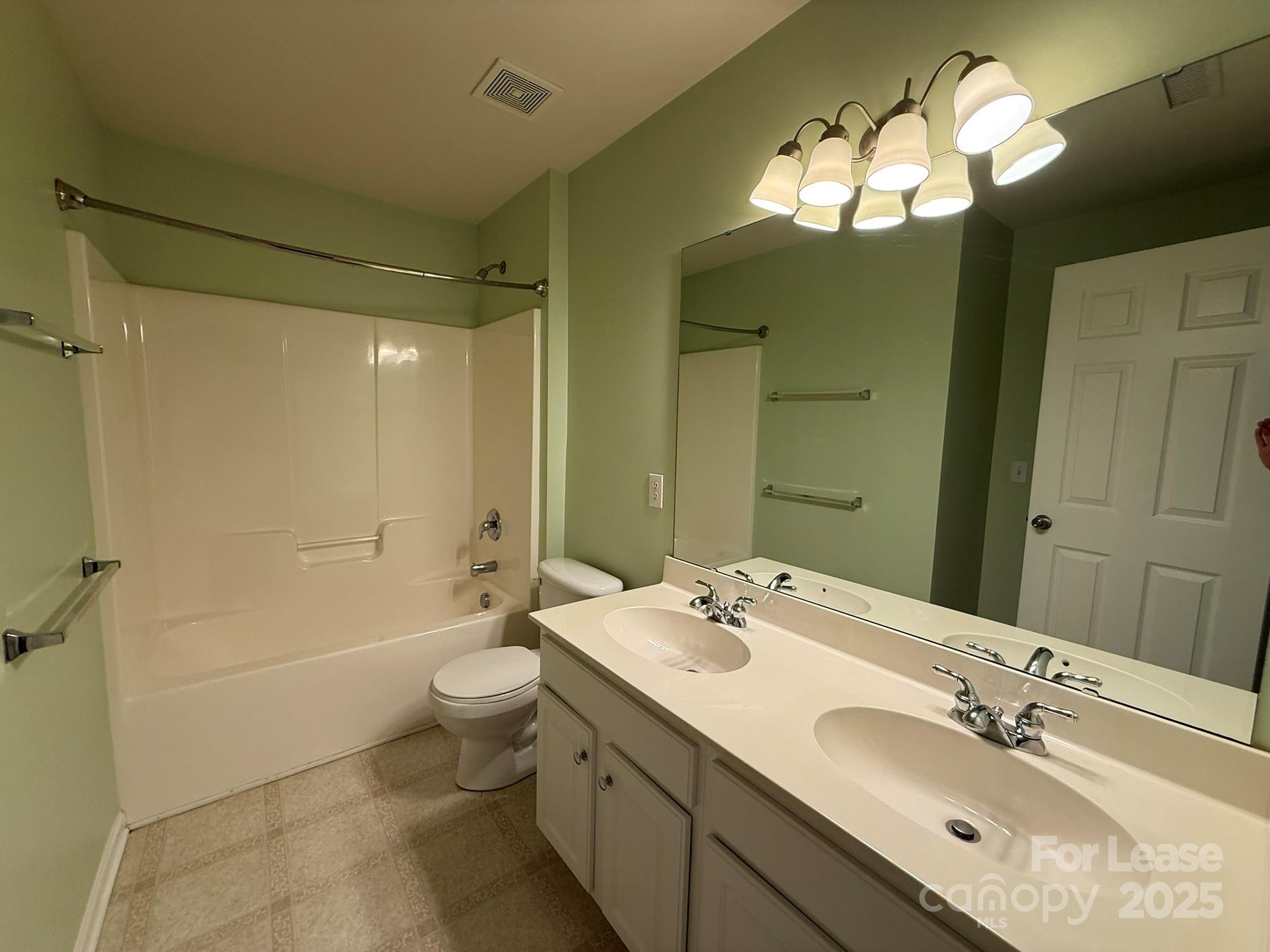 10431 Olde Ivy Way Charlotte, NC 28262 - Photo 21 of 24 a bathroom with a double vanity sink mirror double and toilet