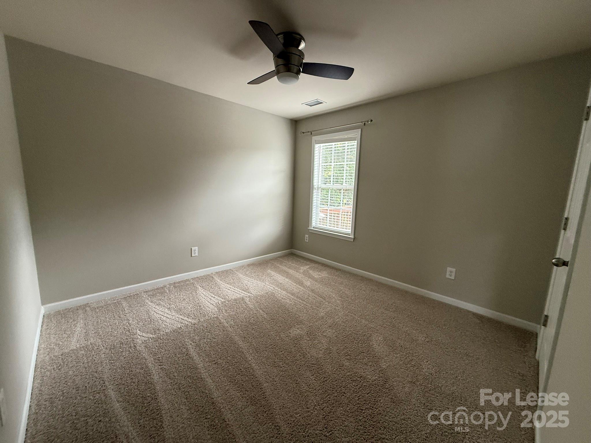 10431 Olde Ivy Way Charlotte, NC 28262 - Photo 22 of 24 a view of an empty room and a window