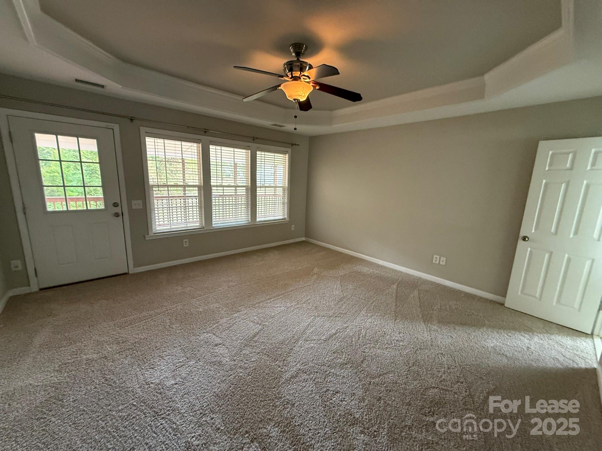 10431 Olde Ivy Way Charlotte, NC 28262 - Photo 10 of 24 an empty room with windows and fan
