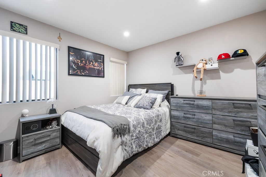 1340 Glenwood Road, Unit 8 Glendale, CA 91201 - Photo 12 of 20 a bedroom with a bed and a chandelier