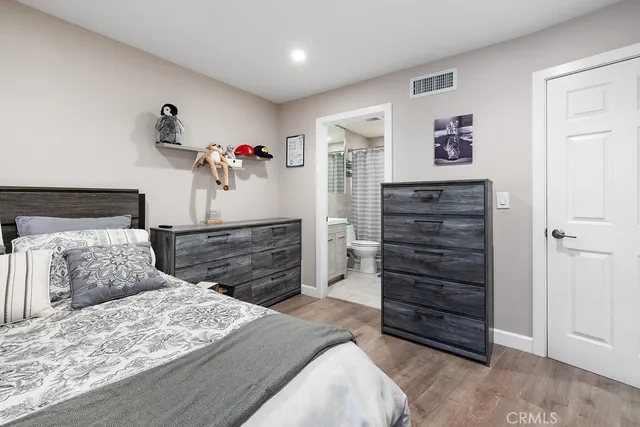 a bedroom with a bed and a dresser