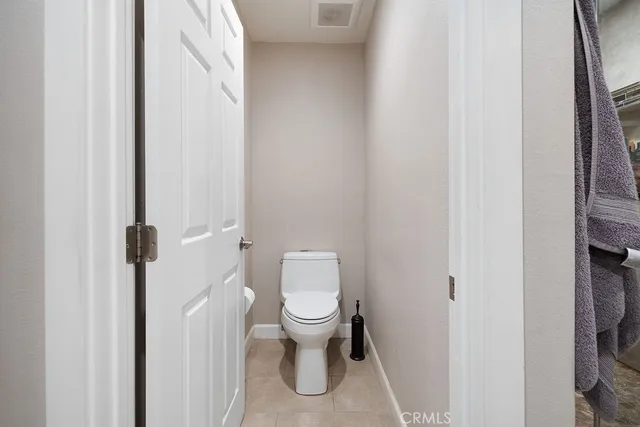 a white toilet sitting next to a shower