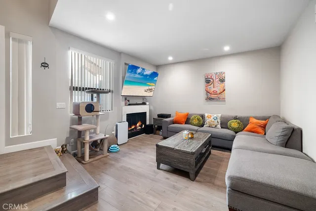 a living room with fireplace furniture and a window