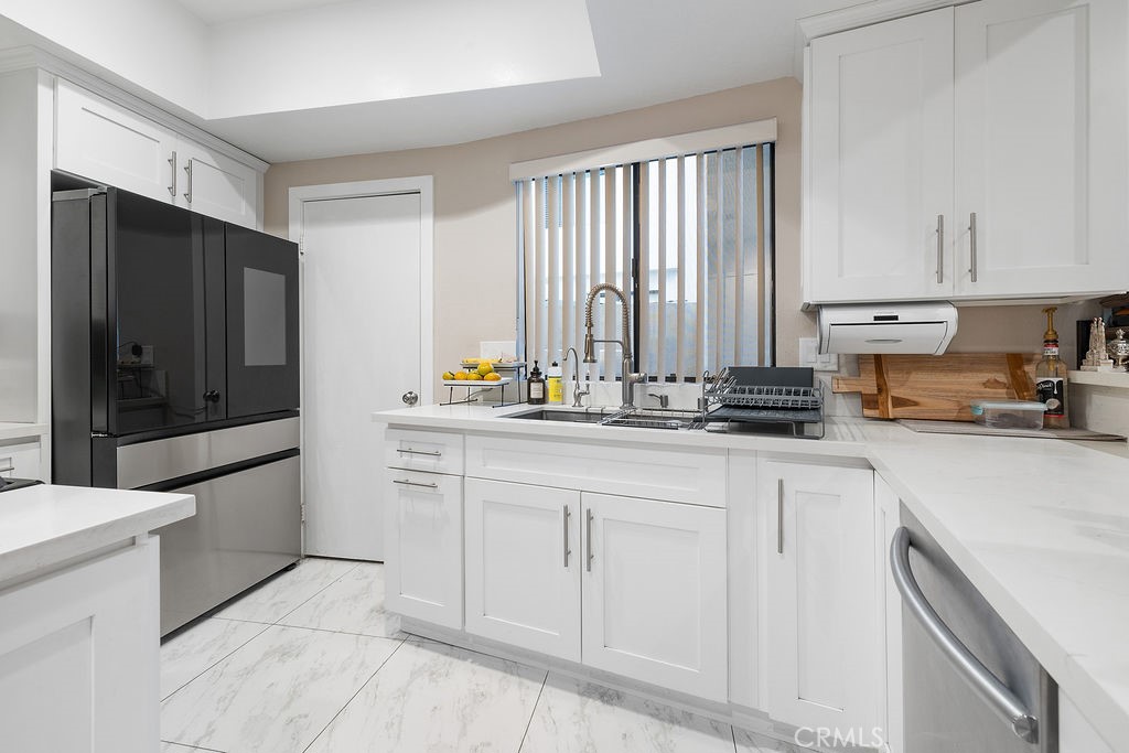 1340 Glenwood Road, Unit 8 Glendale, CA 91201 - Photo 7 of 20 a kitchen with stainless steel appliances a refrigerator sink and cabinets