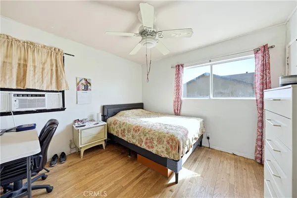 a bedroom with a bed window and a desk